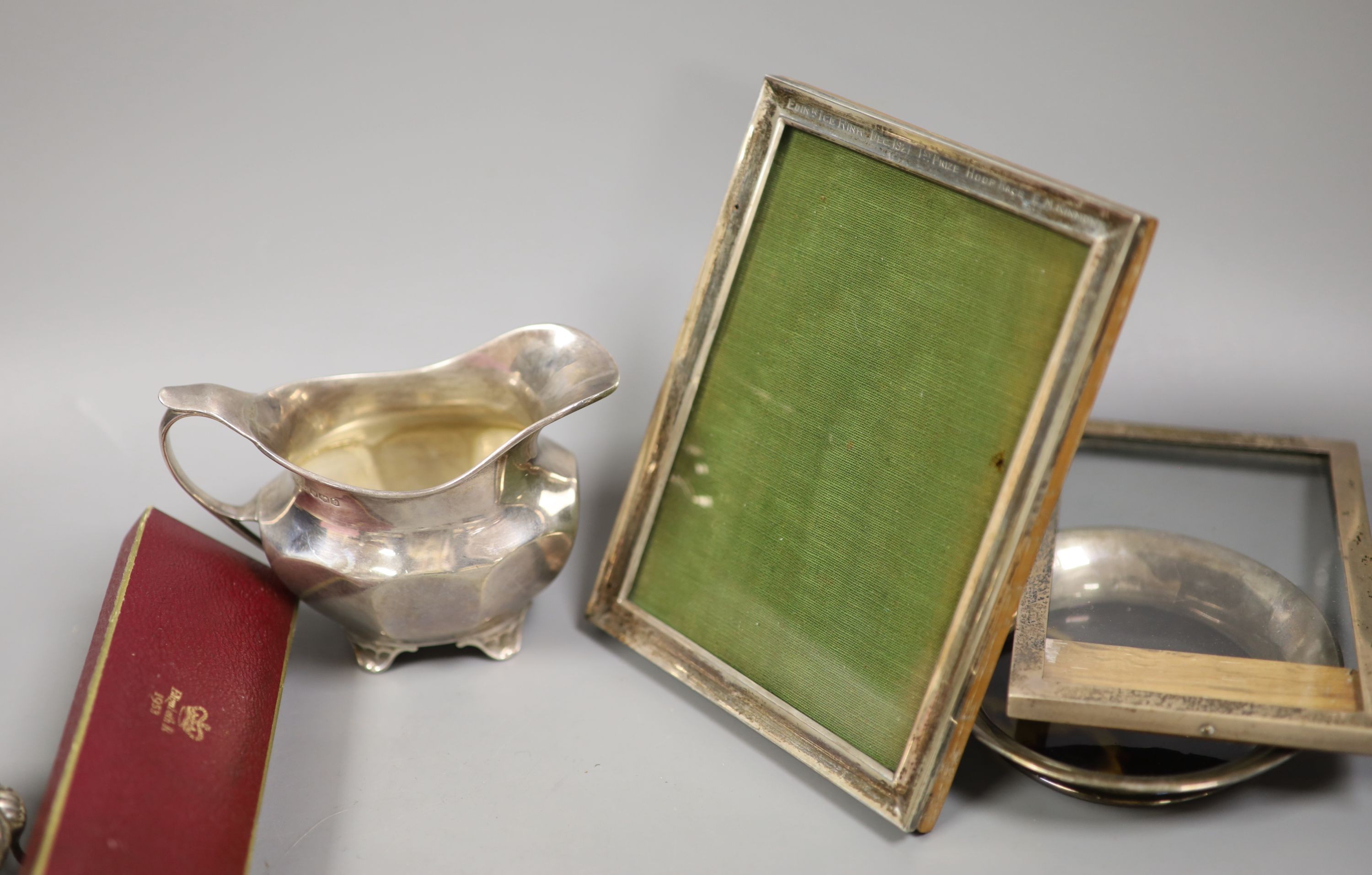 Sundry small silver including a silver trinket box, Victorian salt, two silver cream jugs, three silver dishes, 19th century mother of pearl snuff box, 6cm, pocket watch, photograph frames, etc.